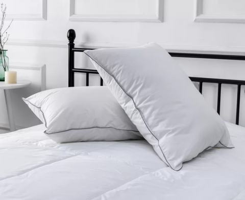 Two Westin® Heavenly Soft Support Polyester Bed Pillows on top of a white bed.