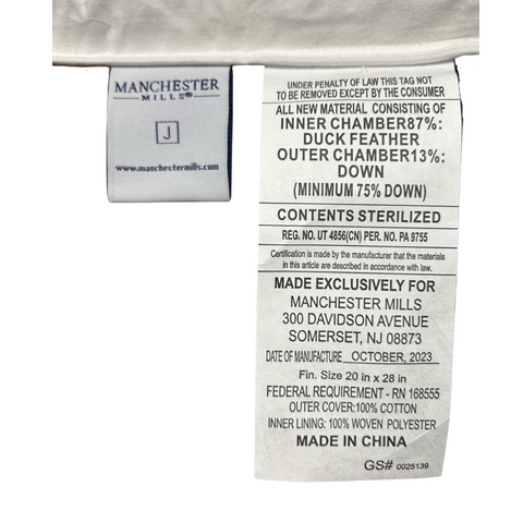 A label for Manchester Mills Down Dreams Classic Soft Pillow feathers on a white shirt.