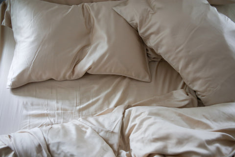 A Pillowtex Copper Infused Bamboo Sheet Set with pillows and sheets on it.