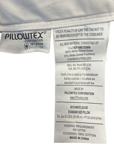A white Pillowtex® high end white goose down pillow displaying material information: 90% white goose feathers, 10% down, and a 100% cotton cover. It also includes care instructions, regulatory compliance.
