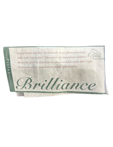 A label from Pillow Factory showcasing the Brilliance Gel Fiber Pillow line, highlighting features such as luxurious soft feel, gel fiber technology, hypoallergenic materials, and machine washable properties.