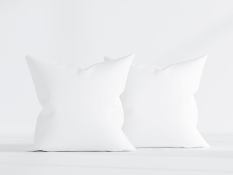 Two Pillowtex Pillow Inserts with White Duck Feather & Down stand side by side against a white minimalist background, their soft textures inviting a sense of calm and comfort.