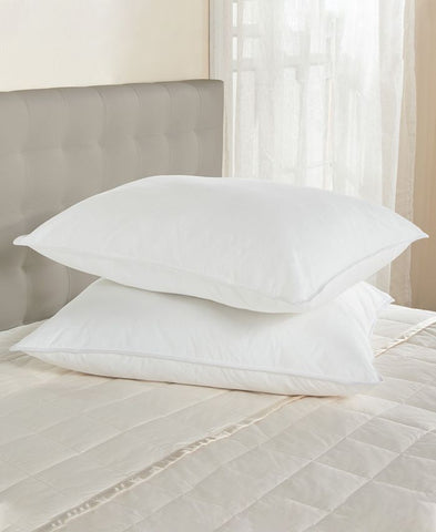 Two Cloud Nine Comforts 50/50 White Goose Down & Feather Luxury Pillows | Medium Support on top of a bed.