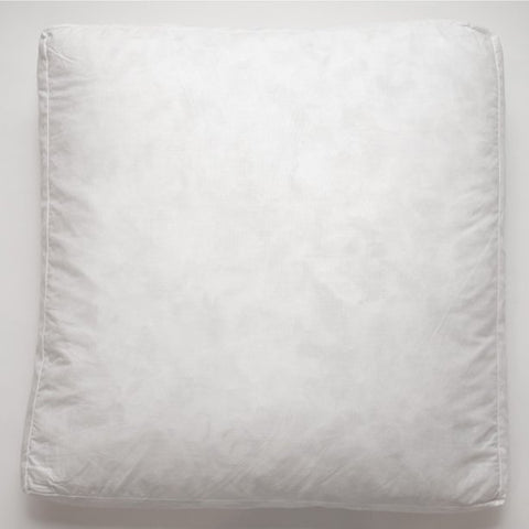 A Down Etc. Square Box Pillow sits on a white surface.
