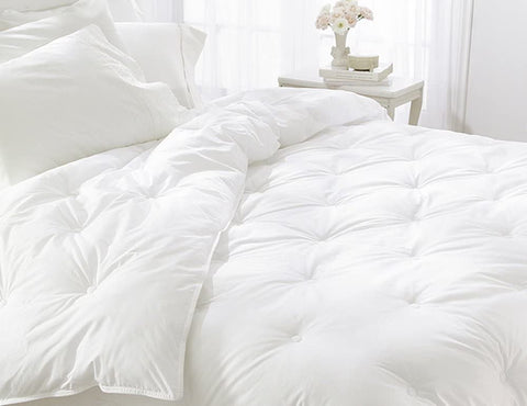 A Restful Nights Down Alternative Comforter on a bed in a bedroom.