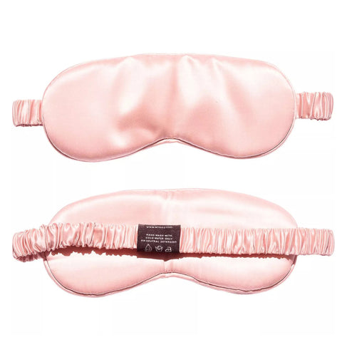 A Pillows.com Mulberry Silk Sleep Eye Mask with Silk Covered Elastic Strap, arranged against a white background, designed to enhance sleep quality by blocking out light for restful sleep.