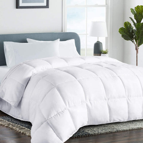 A Dreamy Nights Dream Foam Gel Synthetic Comforter with all-season warmth on a bed in a bedroom.