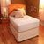 A Restful Nights Egyptian Cotton Mattress Pad with 300 thread count cotton sheets in a room with hardwood floors.
