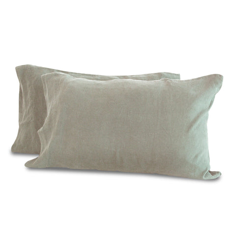 Two soft, rectangular, light gray linen pillows against a white background, suggesting a peaceful and comfortable ambiance suitable for a contemporary home interior with luxury Delilah Home Hemp Pillowcase Set.