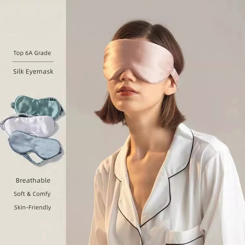 A model wearing a Pillows.com Mulberry Silk Sleep Eye Mask with Silk Covered Elastic Strap demonstrates its comfortable fit, while the image highlights the mask's breathable, soft, and skin-friendly features, accompanied by two additional masks showing