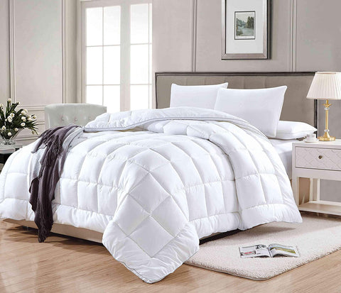 A 300 Thread Count Dreamy Nights Dream Foam Gel Synthetic Comforter on a wooden floor in a bedroom provides luxurious all-season warmth.