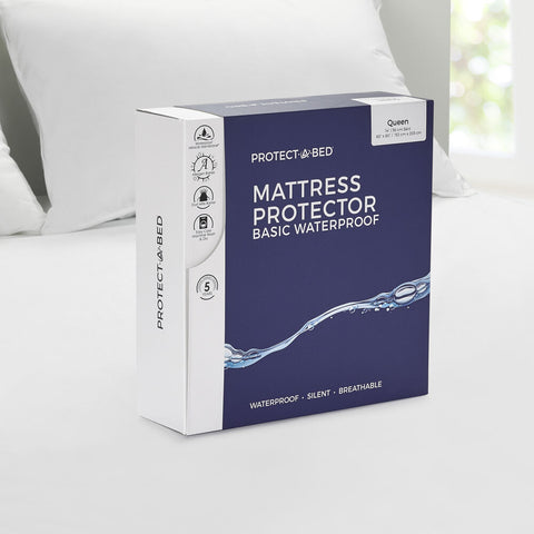 A Protect-A-Bed Basic Waterproof Mattress Protector box on a bed.