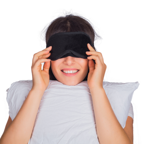 A woman wearing a Carpenter Co. Perfect Choice Platinum Pillow - Standard Size eye mask for comfort.