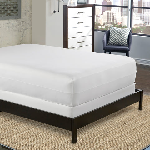 A bed in a bedroom with a PureCare Aromatherapy Total Encasement Mattress Protector on it.