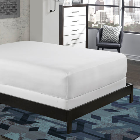 A PureCare Cooling 5-Sided Mattress Protector in a bedroom with a cooling blue and white rug.