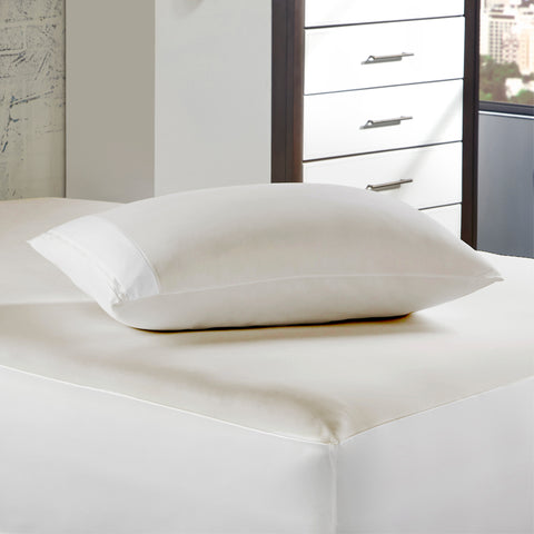 A PureCare Aromatherapy Pillow Protector on top of a bed in a bedroom offers protection benefits.
