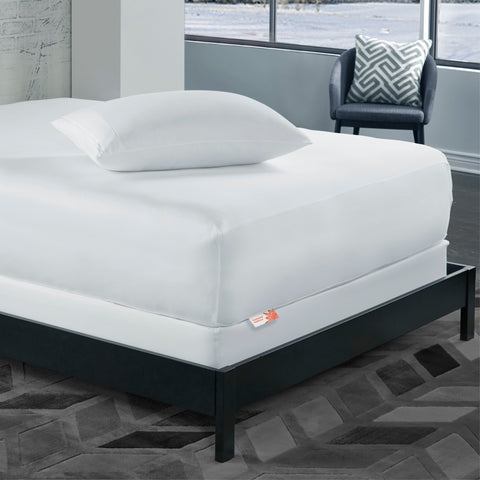 A bed with a PureCare ReversaTemp 5-Sided Mattress Protector.