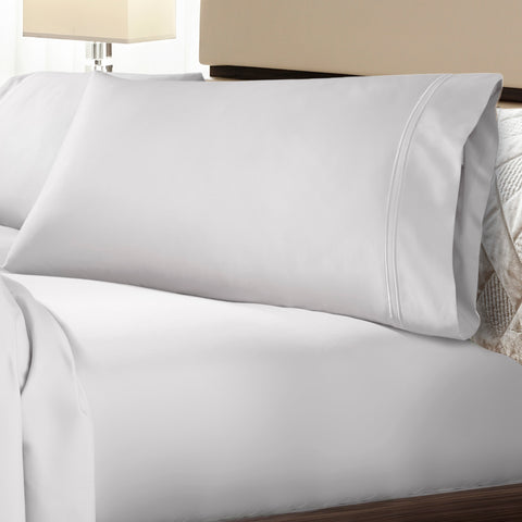 A bed with PureCare Premium Soft Touch TENCEL™ Modal Sheet Set and pillows on it.