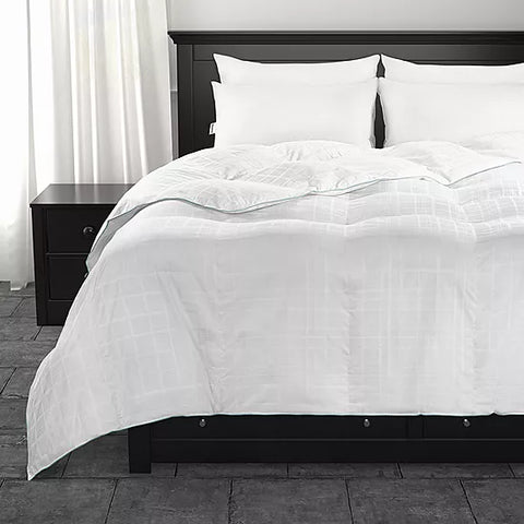 A neatly made black bedframe with matching bedside tables stands in a room with white 400 Thread Count Cotton bedding, accented by subtle geometric patterns and a Hollander Live Comfortably Cooling Cameron Tartan Comforter, creating a modern, minimalist.