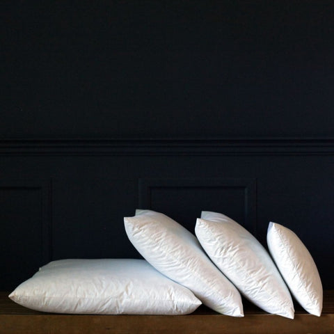 Four Down Etc. Feather Pillow Inserts | Square on a wooden bench.