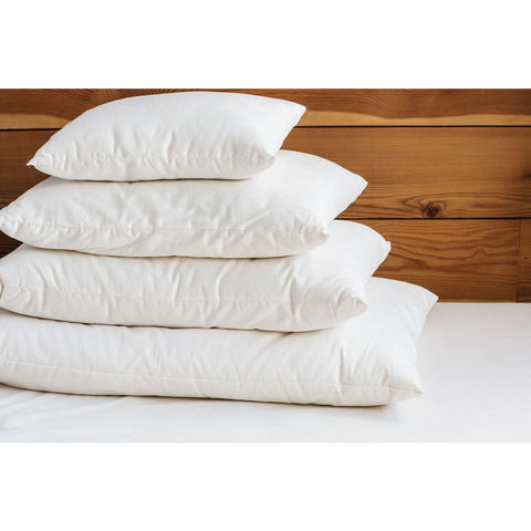 Four Holy Lamb Organics Wool-Filled Bed Pillows stacked on top of each other.