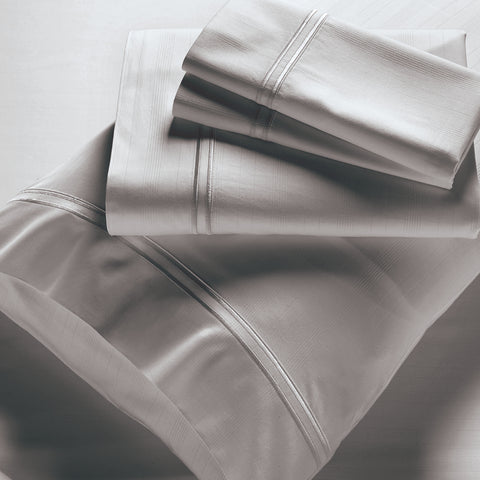 A set of PureCare Premium Bamboo sheets on a white surface.