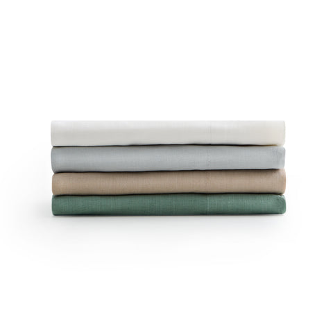 Four Malouf Linen-Weave Cotton Sheet Sets stacked on top of each other.