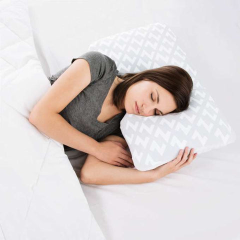 A woman sleeping on a Malouf Shoulder Zoned Gel Dough Pillow with a chevron pattern.