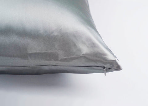 A Pillowtex 100% Mulberry Silk Pillowcase with Zipper Enclosure, 16 Momme on a white surface, perfect for skin care.