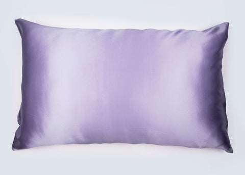 A soft, rectangular lilac Pillowtex 16 momme Mulberry silk pillowcase on a white background, showcasing a subtle sheen and smooth texture, indicative of a luxurious home accessory ideal for hair and skin