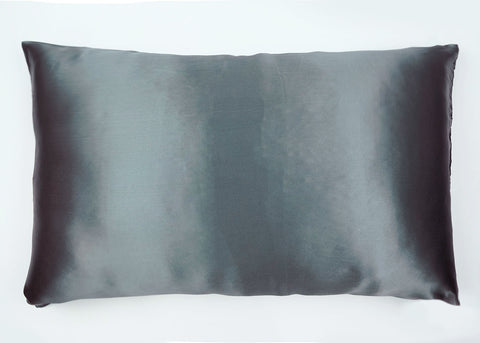 A silky, smooth Pillowtex Mulberry silk pillowcase in tones of gray softly transitions from dark to light, providing a luxurious and comfortable accent for modern home decor and hair and skin care.