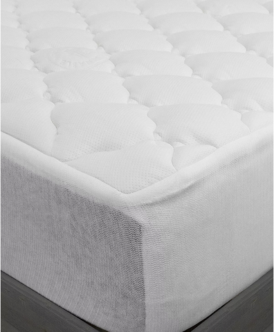 A close-up of a Pillowtex Bamboo Mattress Topper with a white waterproof mattress pad.