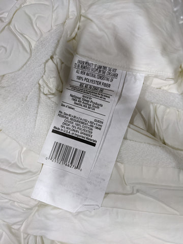 A close up of a white dress with a Restful Nights label on it.