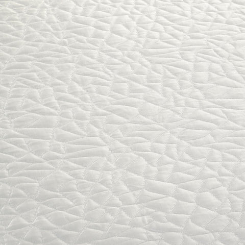This close up image features a white mattress surface with a Protect-A-Bed Snow Mattress Protector.