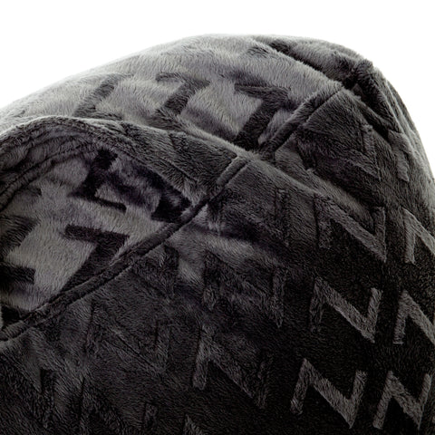 A close up of a black Malouf Lounge Pillow with comfortable shredded foam fill.