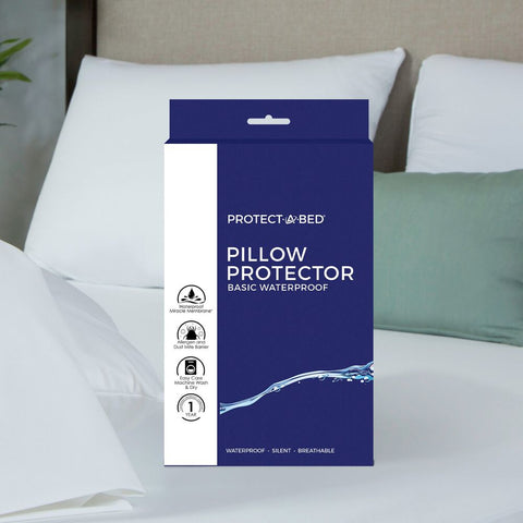 A Protect-A-Bed Basic Waterproof Pillow Protector is sitting on top of a bed.