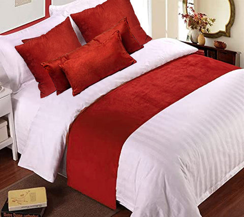 A high quality bed with red and white Pillowtex Faux Suede decorative throw pillows and bedding.