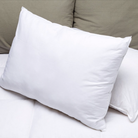 A white Martex Brentwood Gold Pillows on top of a bed.