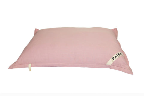 A Delilah Home Pillow Dog Bed made of organic cotton on a white background.