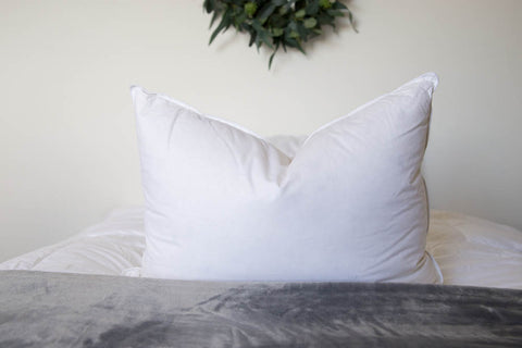 A Down Etc. 50% White Goose Down / 50% White Goose Feather Pillow on the bed provides a supportive sleep experience.