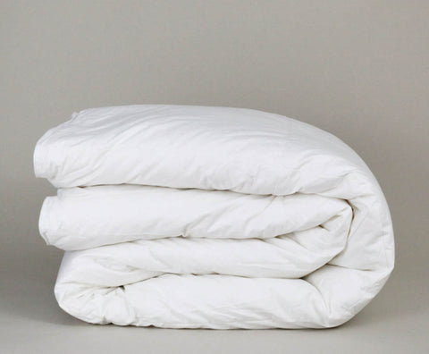 A Down Etc. Winter Weight Down Comforter on a grey background made with White Goose Down.