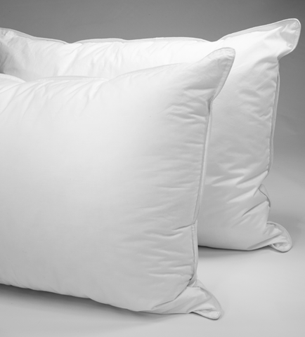 Two Dream Essence Down Alternative Pillows from Sysco Guest Supply on a grey background.