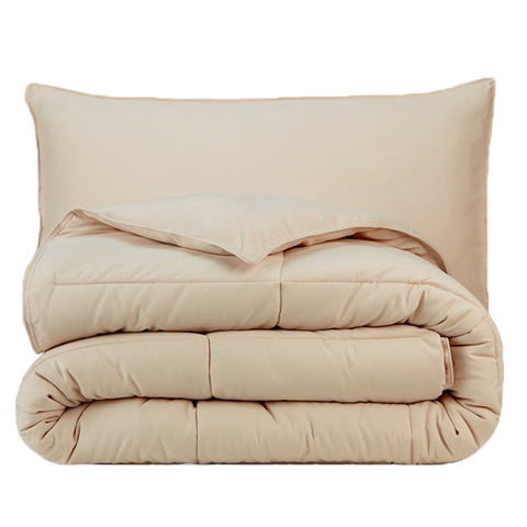 A beige Pillowtex Essential Bedding Package | All Season Comforter with Matching Pillows on a white background.