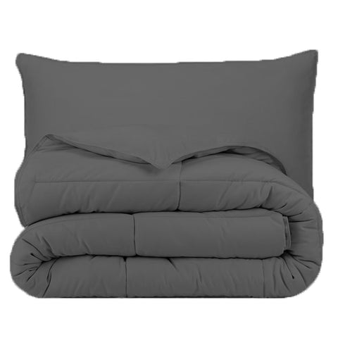 A grey comforter set with a Pillowtex Essential Bedding Package | All Season Comforter with Matching Pillows on top.