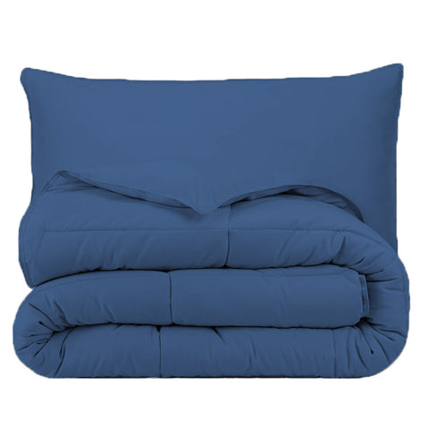 A blue Pillowtex Essential Bedding Package with a cozy pillow on top.
