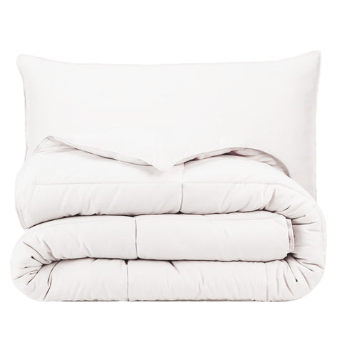 A Pillowtex Essential Bedding Package - All Season Comforter with Matching Pillows in dream in color on a white background.