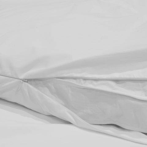 A white bed with a white cover and Down Etc. Featherbed Protector | Zippered & 100% Cotton.