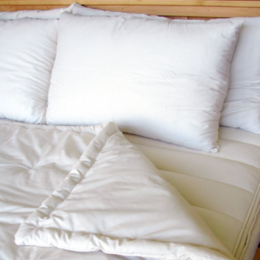 An Holy Lamb Organics Wool Comforter - Perfect Comfort on a bed.
