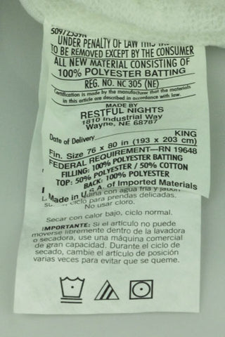 A label on the back of a Restful Nights Easy Rest Mattress Pad | Deep Mattress Fit towel.