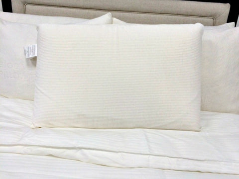A Latex International Rejuvenite Classic Low Profile Pillow on the bed.